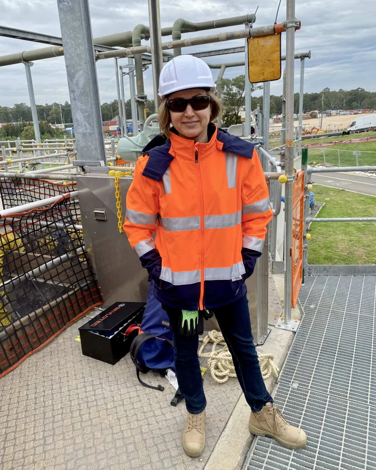 Inna on site in high visibility clothing and hard hat, from her years as a project engineer
